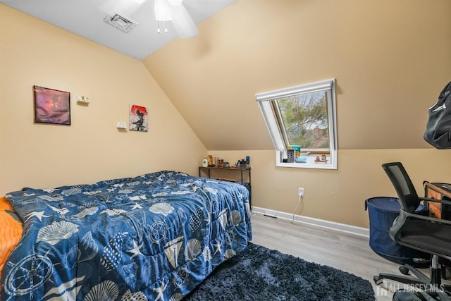 bedroom with wood-type flooring and vaulted ceiling