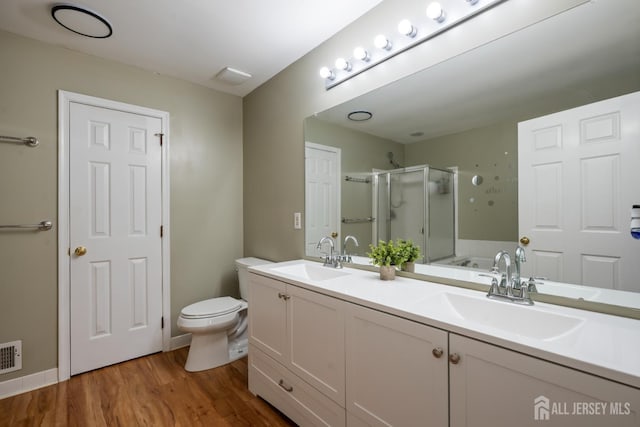 181 Windsong Cir E, Brunswick, NJ 08816 - bathroom featuring a shower stall, double vanity, wood finished floors, and toilet