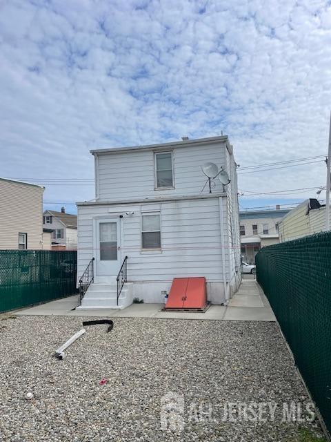 27 Edwin St, Carteret, NJ 07008 - rear view of property featuring entry steps and a fenced backyard