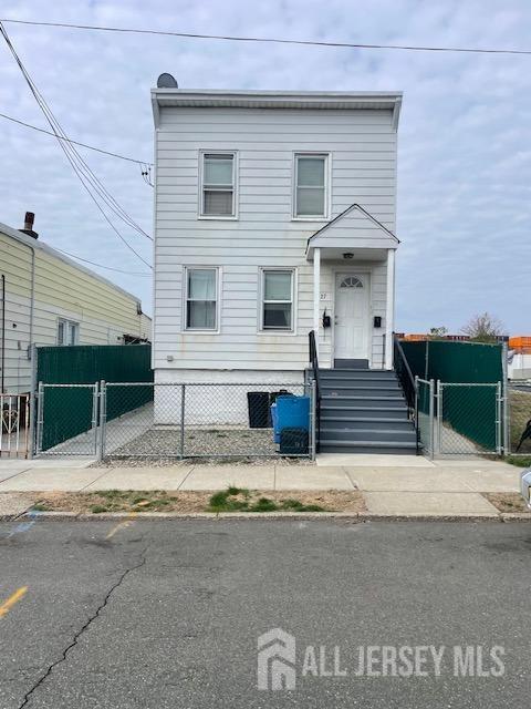 27 Edwin St, Carteret, NJ 07008 - view of front of property with a gate and fence