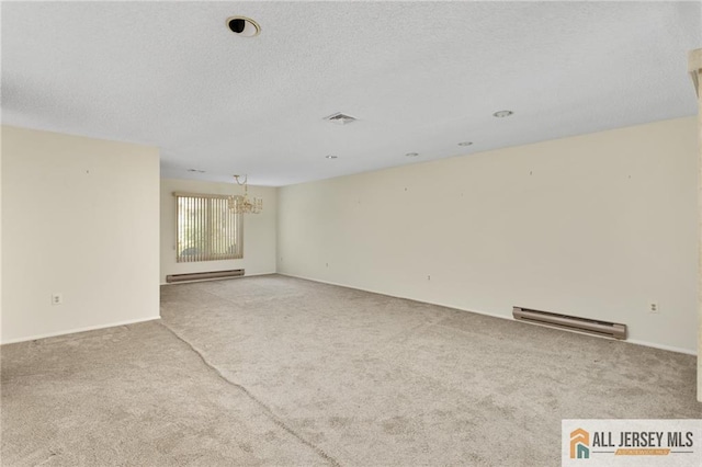 747 Marlton Rd Unit 747A, Monroe, NJ 08831 - carpeted spare room with baseboard heating, a chandelier, a baseboard heating unit, and a textured ceiling