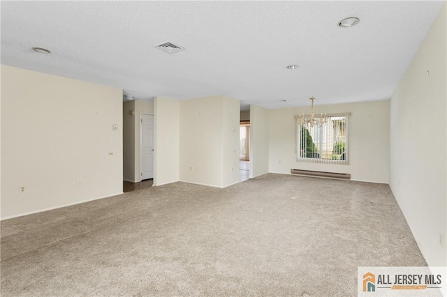 747 Marlton Rd Unit 747A, Monroe, NJ 08831 - carpeted empty room featuring a baseboard heating unit, a chandelier, and a textured ceiling