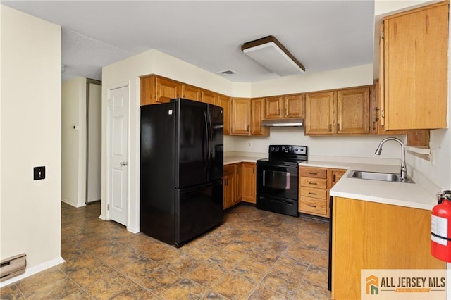 747 Marlton Rd Unit 747A, Monroe, NJ 08831 - kitchen featuring black appliances, a sink, under cabinet range hood, light countertops, and brown cabinetry