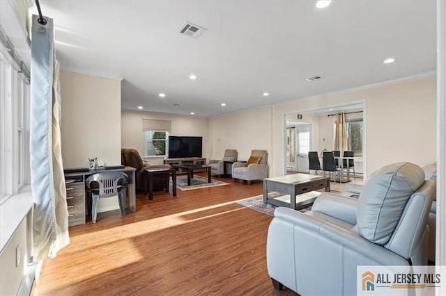 living room featuring recessed lighting, visible vents, crown molding, and wood finished floors