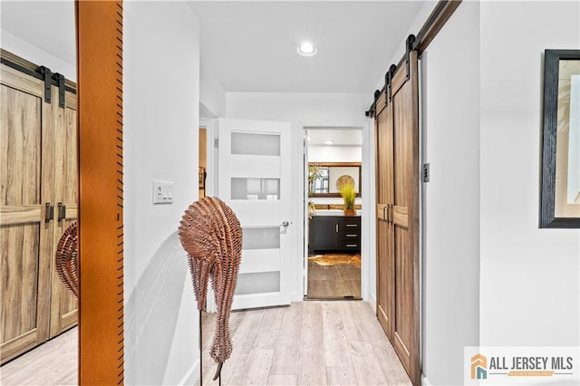 68 Winthrop Rd Unit 68B, Monroe, NJ 08831 - hallway featuring a barn door, light wood-style floors, built in features, and recessed lighting