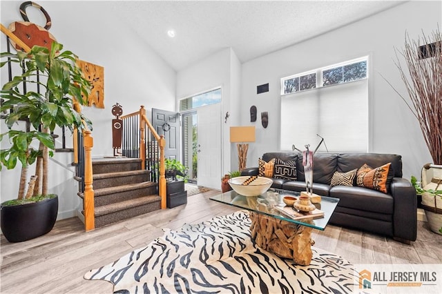 68 Winthrop Rd Unit 68B, Monroe, NJ 08831 - living room featuring high vaulted ceiling, stairway, wood finished floors, recessed lighting, and a textured ceiling