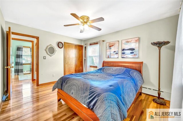 70 Lockwood Ave, Woodbridge Proper, NJ 07095 - bedroom featuring baseboard heating, light wood-type flooring, a closet, and baseboards