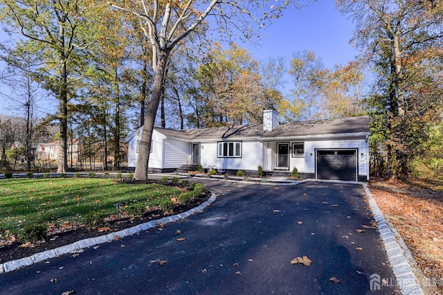 ranch-style home with a front yard and a garage