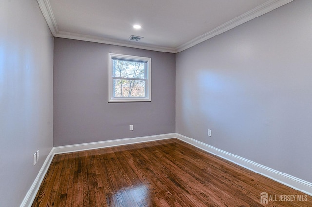 empty room featuring dark hardwood / wood-style floors and ornamental molding