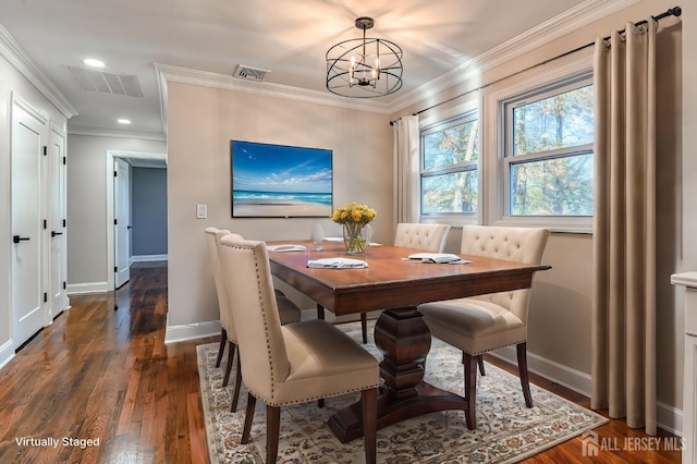 dining area with dark hardwood / wood-style flooring, an inviting chandelier, and ornamental molding