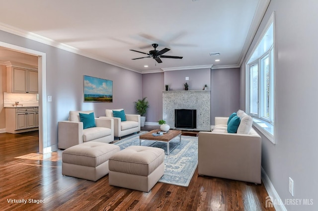 living room with dark hardwood / wood-style floors, ceiling fan, and crown molding