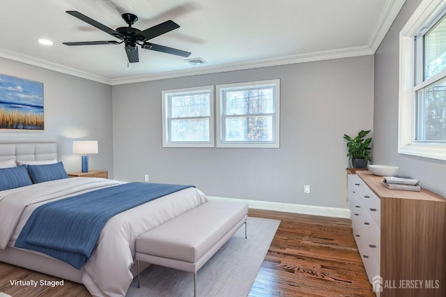 bedroom featuring ceiling fan, dark hardwood / wood-style flooring, crown molding, and multiple windows