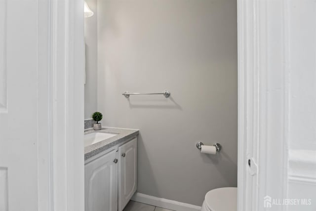 bathroom featuring tile patterned floors, toilet, and vanity