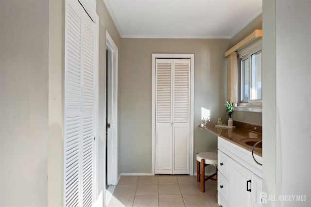 bathroom featuring ornamental molding, tile patterned floors, and vanity