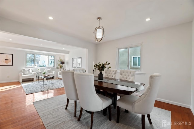 dining room with hardwood / wood-style flooring and a wealth of natural light