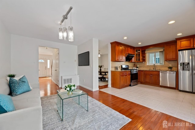 tiled living room with sink and a chandelier