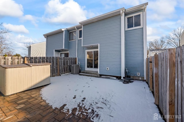 rear view of house with central AC and a patio