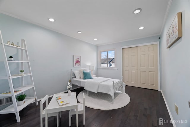 bedroom with dark hardwood / wood-style floors, ornamental molding, and a closet