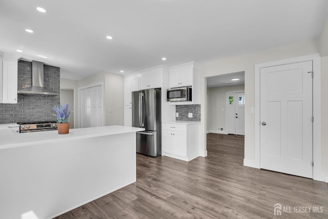 18 Heritage Dr, Edison, NJ 08820 - kitchen featuring wall chimney range hood, appliances with stainless steel finishes, decorative backsplash, white cabinets, and light countertops