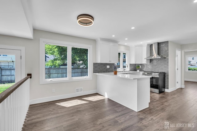 18 Heritage Dr, Edison, NJ 08820 - kitchen featuring stainless steel range oven, wall chimney range hood, white cabinets, plenty of natural light, and recessed lighting
