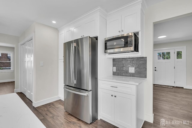 18 Heritage Dr, Edison, NJ 08820 - kitchen with stainless steel appliances, plenty of natural light, tasteful backsplash, white cabinetry, and recessed lighting