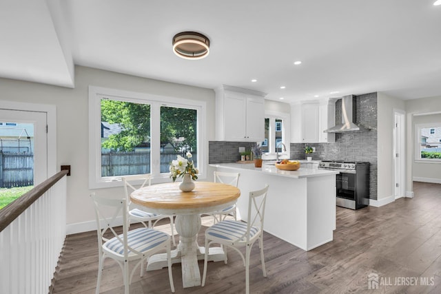 18 Heritage Dr, Edison, NJ 08820 - kitchen featuring stainless steel range, wall chimney range hood, backsplash, white cabinets, and light countertops