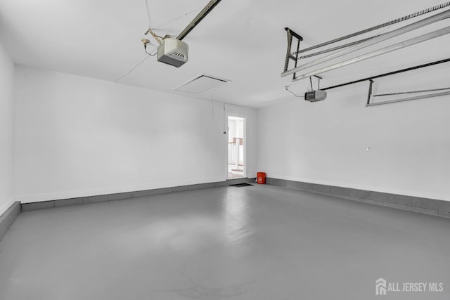 18 Heritage Dr, Edison, NJ 08820 - garage with a garage door opener and baseboards