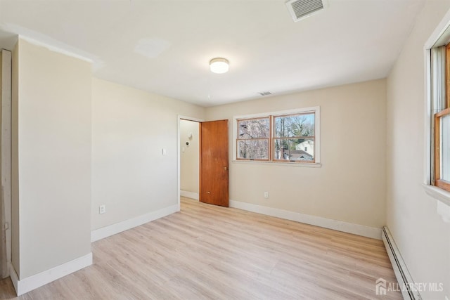 114 Pine Island Ter, Old Bridge, NJ 07735 - empty room featuring a baseboard radiator, wood finished floors, and baseboards