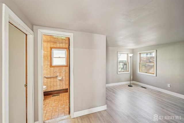 114 Pine Island Ter, Old Bridge, NJ 07735 - empty room featuring plenty of natural light, baseboards, and light wood-style floors