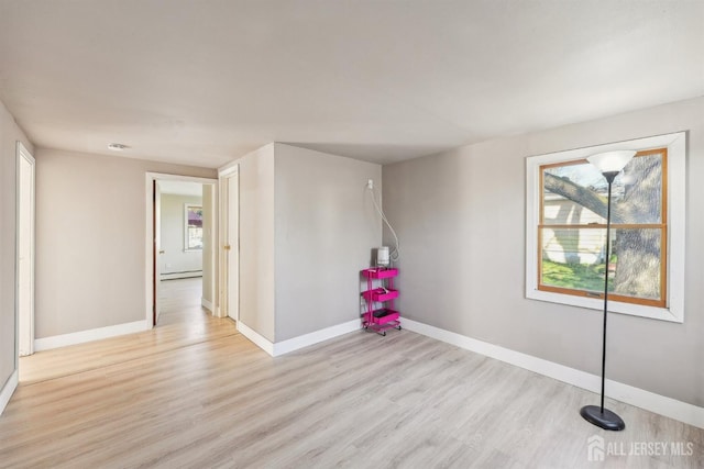114 Pine Island Ter, Old Bridge, NJ 07735 - spare room with baseboard heating, wood finished floors, and baseboards