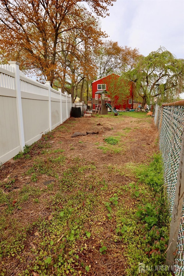 114 Pine Island Ter, Old Bridge, NJ 07735 - fenced backyard with a playground