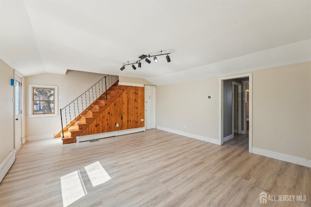 114 Pine Island Ter, Old Bridge, NJ 07735 - unfurnished living room featuring a baseboard radiator, lofted ceiling, light wood-style floors, baseboards, and stairs