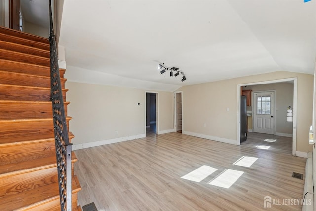 114 Pine Island Ter, Old Bridge, NJ 07735 - unfurnished living room with stairway, light wood finished floors, lofted ceiling, and baseboards