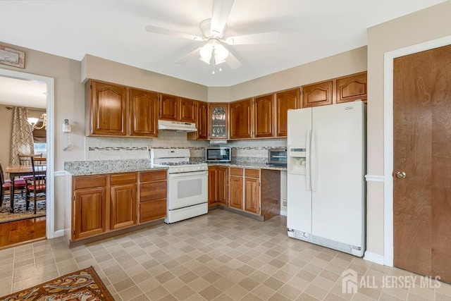 1010 Dorn Ave, Middlesex, NJ 08846 - kitchen featuring white appliances, under cabinet range hood, and brown cabinets