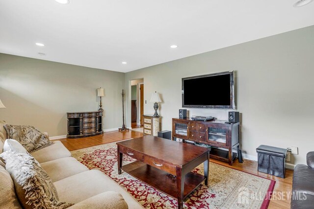 1010 Dorn Ave, Middlesex, NJ 08846 - living room featuring wood finished floors, baseboards, and recessed lighting