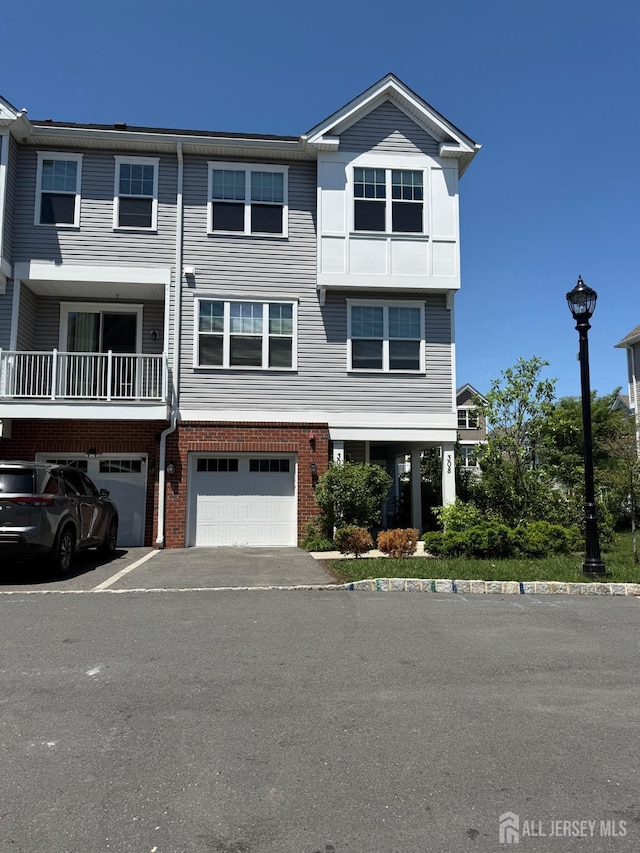 307 Dickson Ct, Highland Park, NJ 08904 - view of front of home featuring a garage, brick siding, and driveway