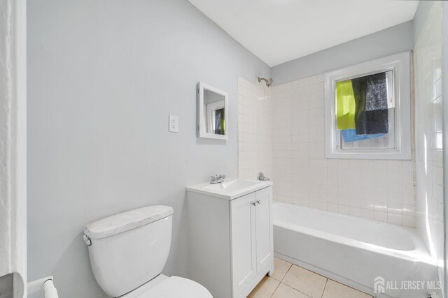 full bathroom with tile patterned flooring, vanity, toilet, and tiled shower / bath combo