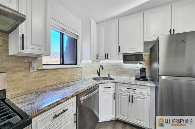 kitchen featuring white cabinetry, stainless steel appliances, and sink