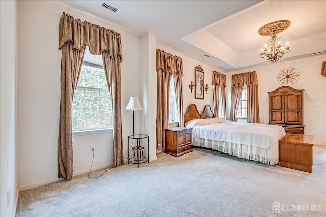 bedroom featuring carpet, visible vents, baseboards, an inviting chandelier, and a raised ceiling