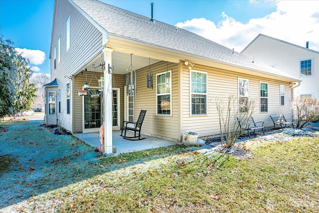 back of house featuring a patio and a lawn