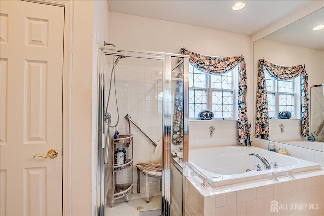 full bath with a shower stall, a bath, and recessed lighting