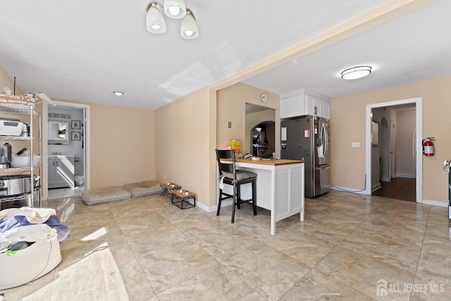 living room featuring marble finish floor and baseboards