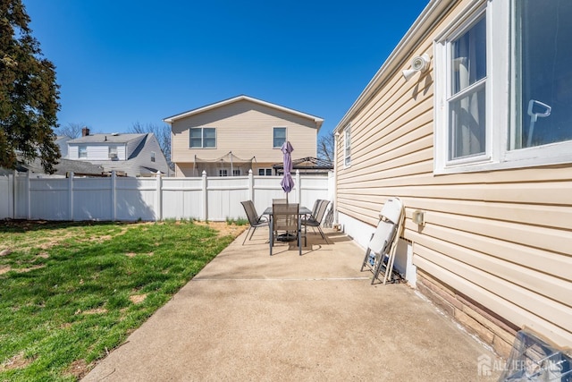 view of patio featuring outdoor dining space and fence