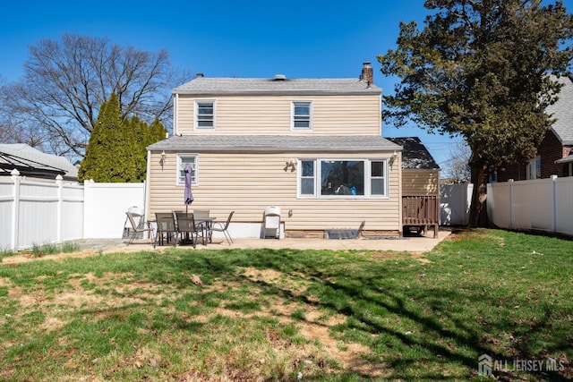 back of house with a lawn, a fenced backyard, and a patio