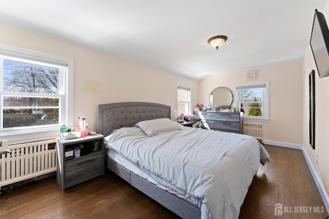 bedroom featuring radiator, baseboards, and dark wood-type flooring