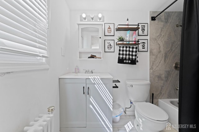 bathroom featuring radiator heating unit, tile patterned floors, toilet, vanity, and bathtub / shower combination