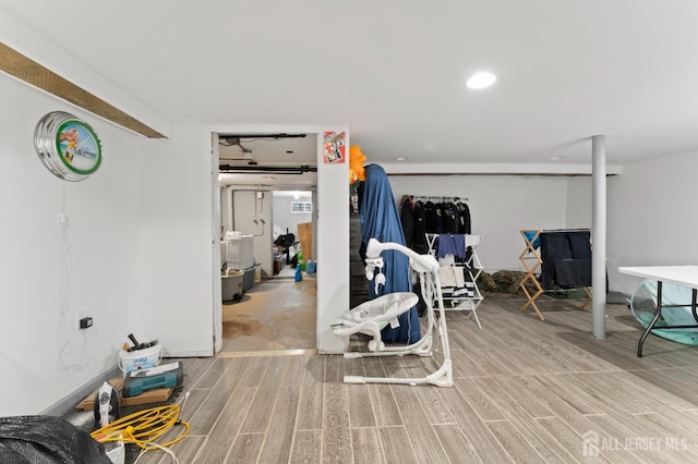 finished below grade area featuring wood finished floors and recessed lighting