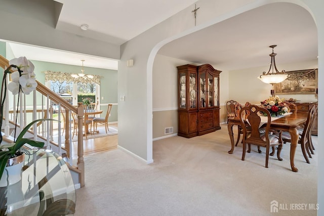 46 Hosford Ave, Leonardo, NJ 07737 - dining space featuring arched walkways, a chandelier, light carpet, and baseboards