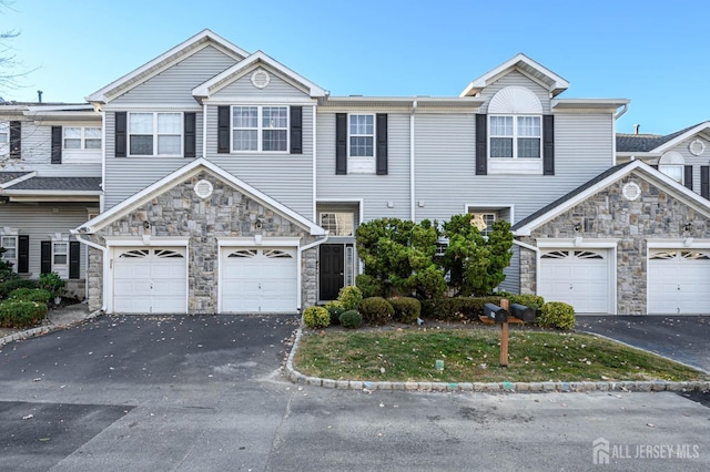 31 Capica Ct Unit 79, Old Bridge, NJ 08879 - view of property featuring stone siding and asphalt driveway