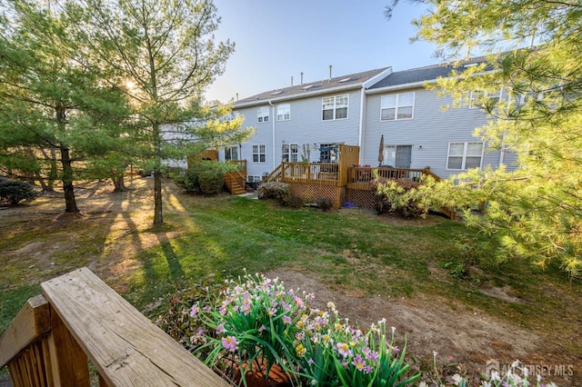 31 Capica Ct Unit 79, Old Bridge, NJ 08879 - rear view of property featuring a deck and a lawn